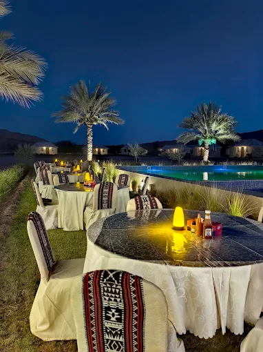 Romantic candlelit outdoor dining table setup beside the pool
