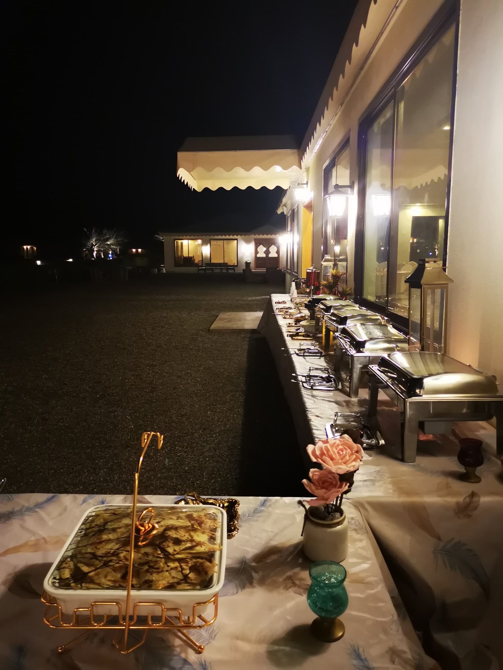 Lantern-lit outdoor dining patio at Desert Rose Camp