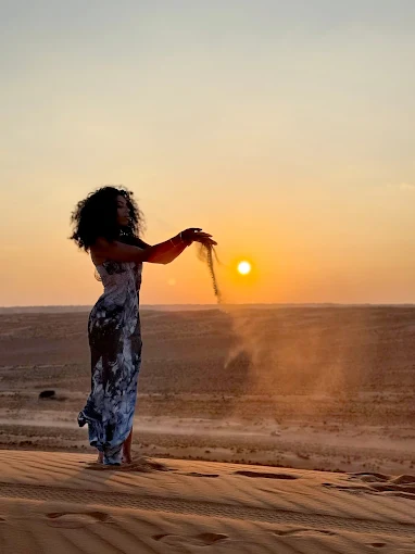 Joyful silhouette posing against the sunset glow