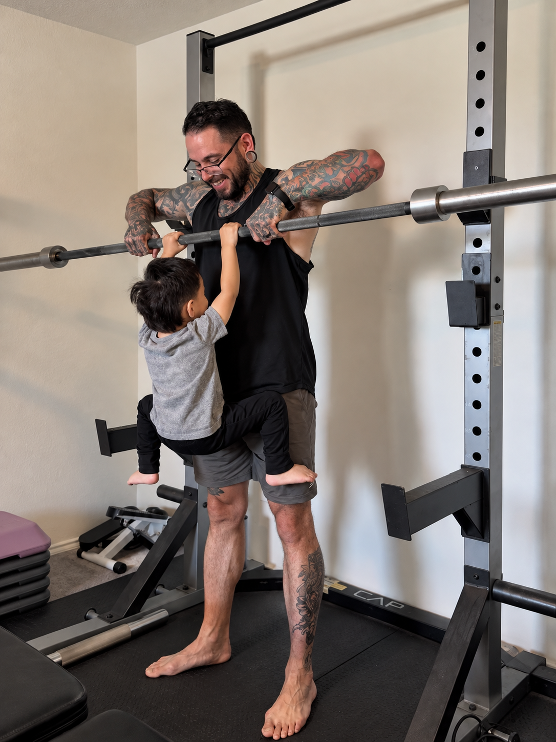 Sam Rodriguez lifting his son in the home gym rack