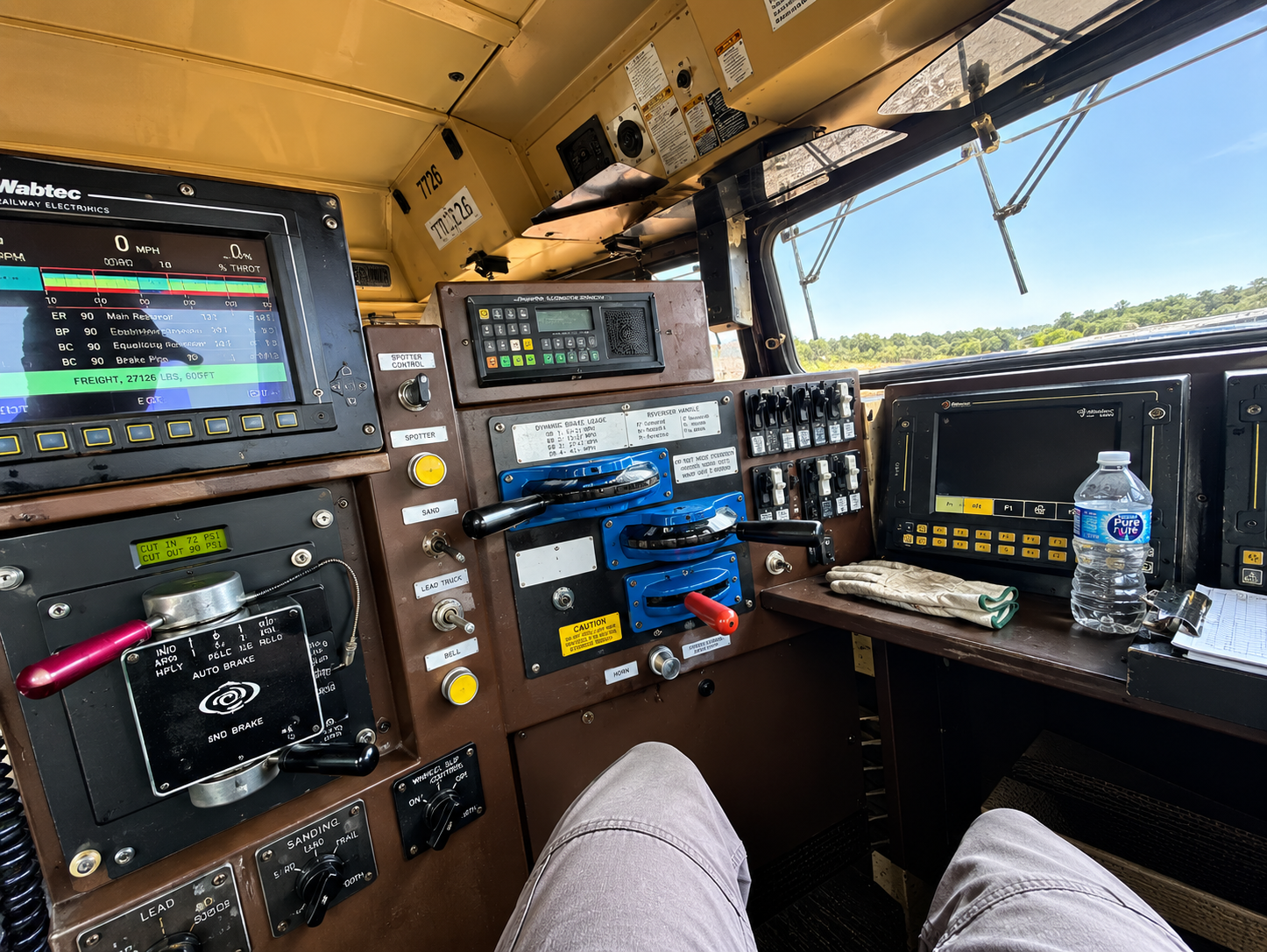 Sam Rodriguez working inside locomotive cab controls
