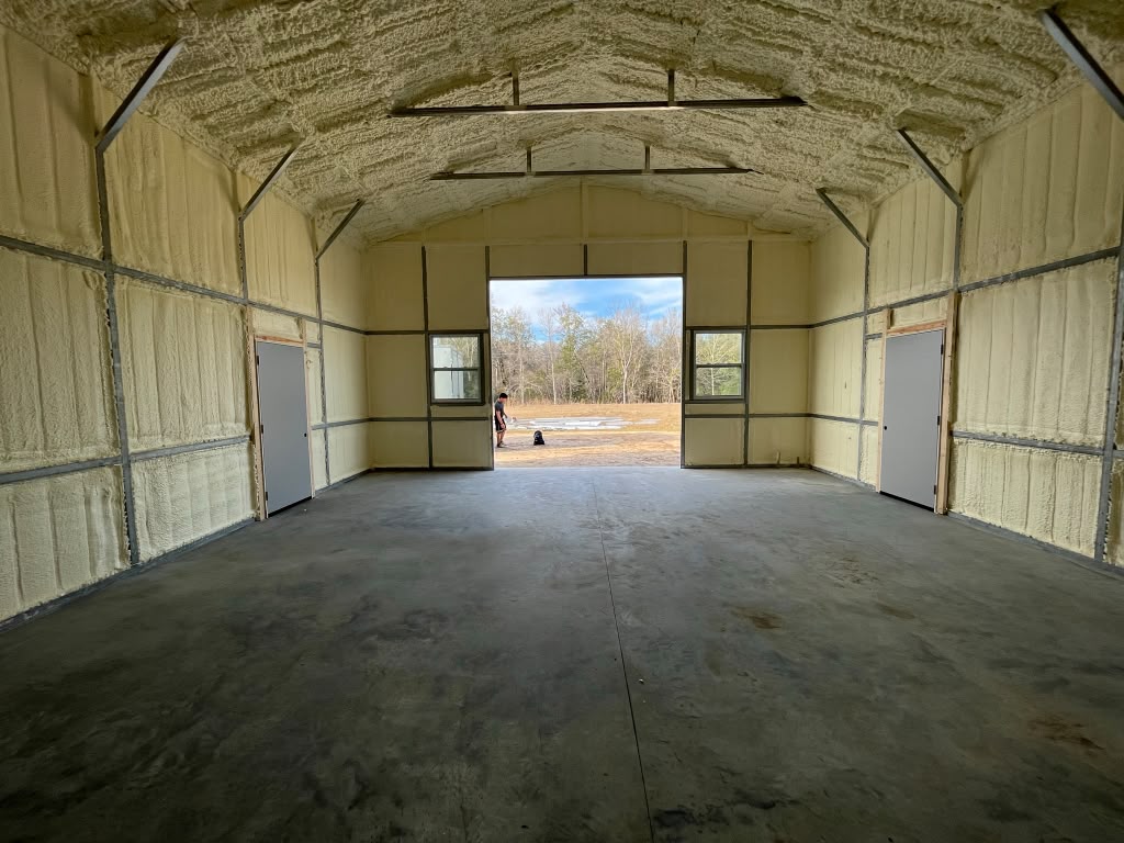 Spacious pole barn workshop spray foam envelope with dual entry doors in Augusta GA