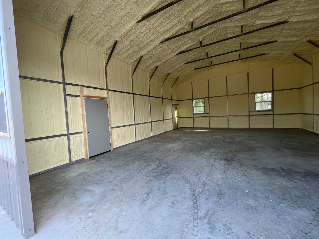Commercial metal building spray foam envelope with framed entry doors in Rincon GA