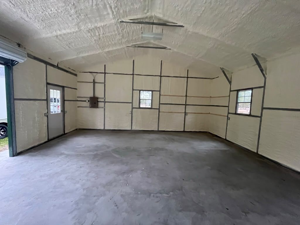 Finished spray foam insulation shell with residential glass entry door in Springfield GA
