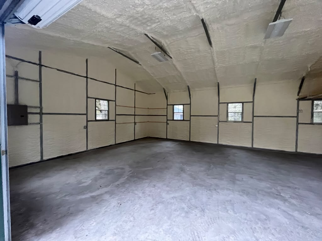Deep interior metal building spray foam seal around electrical sub-panel in Guyton GA