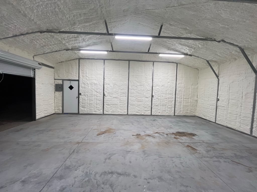 Complete spray foam envelope in metal garage with entry door and lighting in Statesboro GA