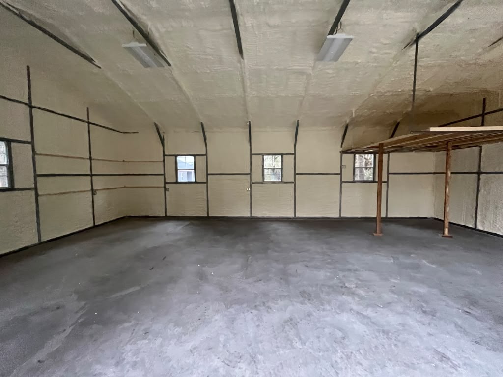 Spray foam insulation in workshop with storage mezzanine and multiple windows in Savannah GA