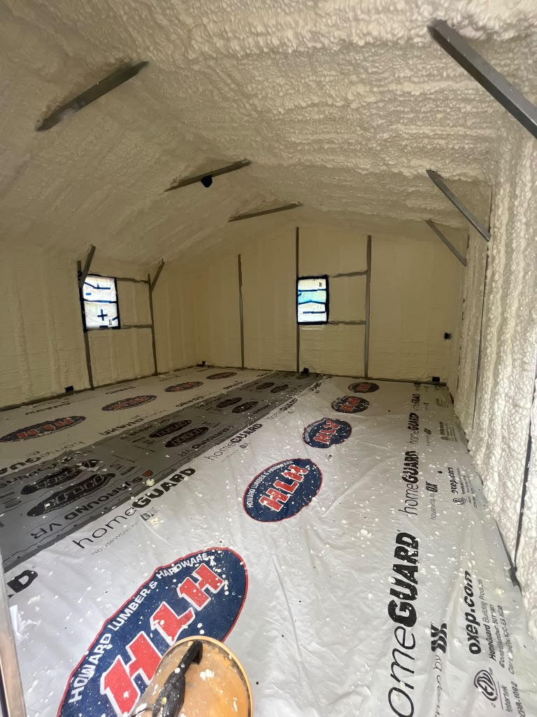 Sealed workshop spray foam insulation with floor protection by Coastal Synergy in Statesboro GA