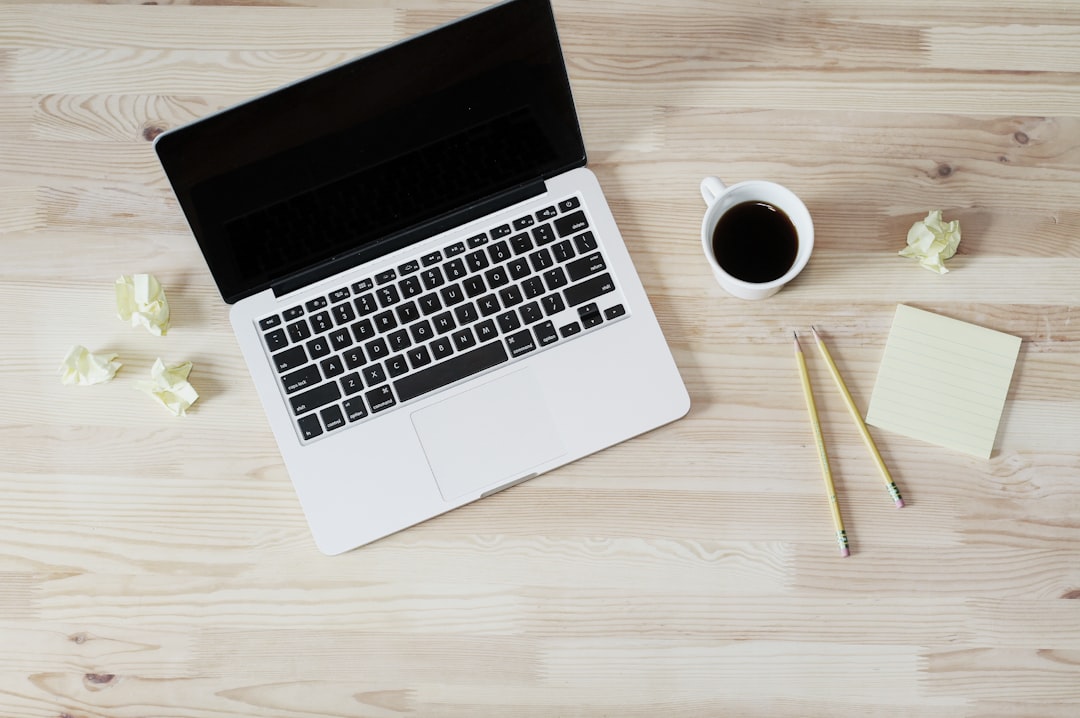 Laptop, coffee and notes on a wooden desk