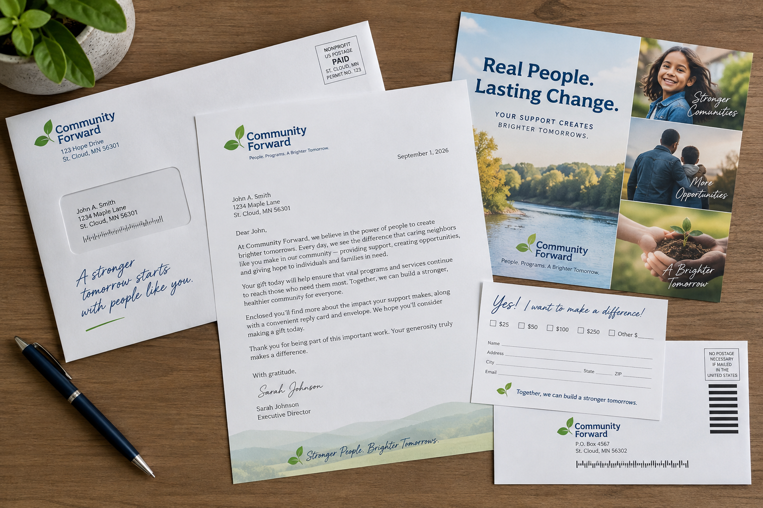 Overhead view of complete nonprofit appeal package spread out on a desk with envelopes, letter, insert, and remittance reply card