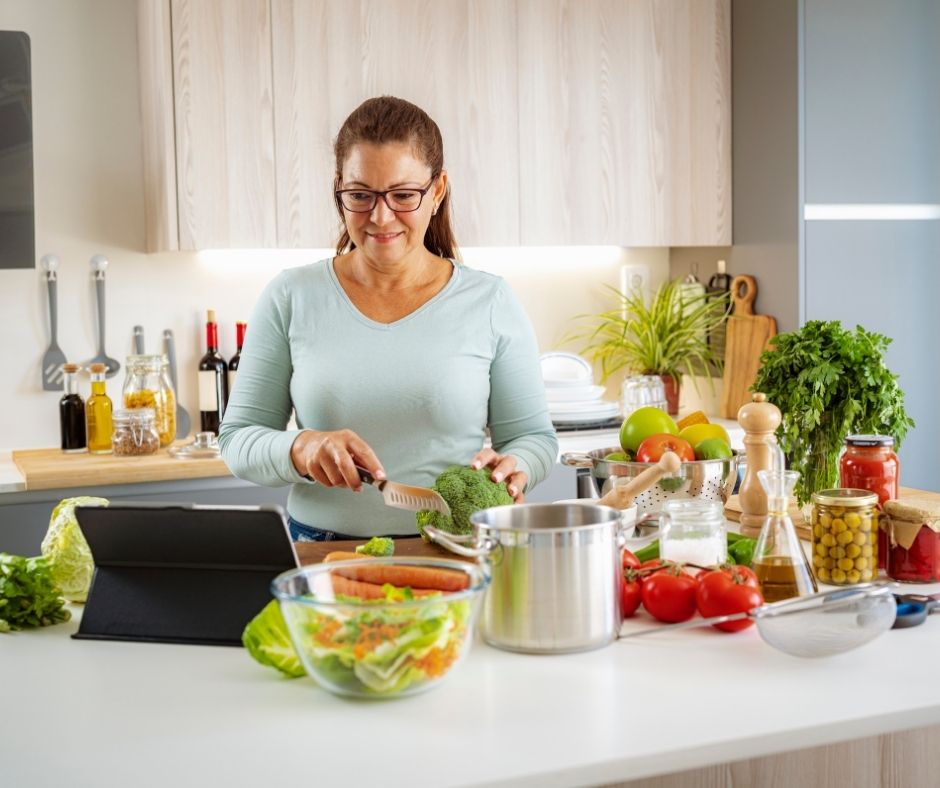 Woman preparing fresh wholesome vegetables in a bright kitchen
