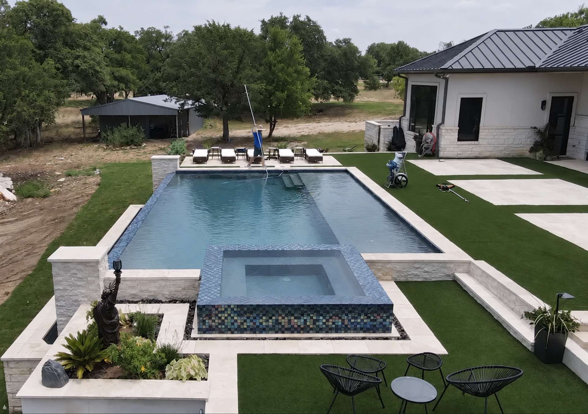 Completed custom geometric pool and raised tiled spa remodel in Georgetown Texas