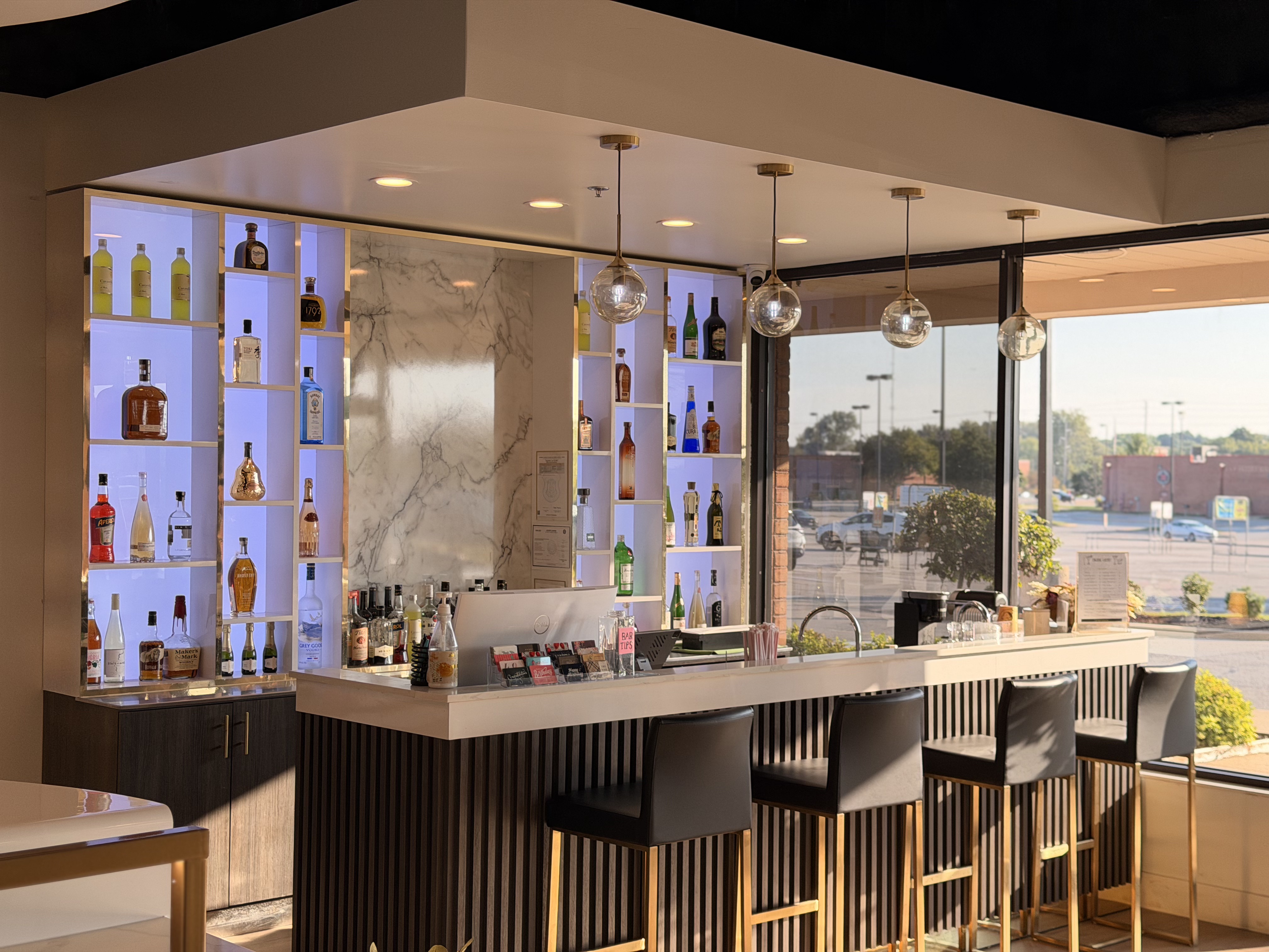 Nail Crew Lounge bar area with cocktails and warm wood counter