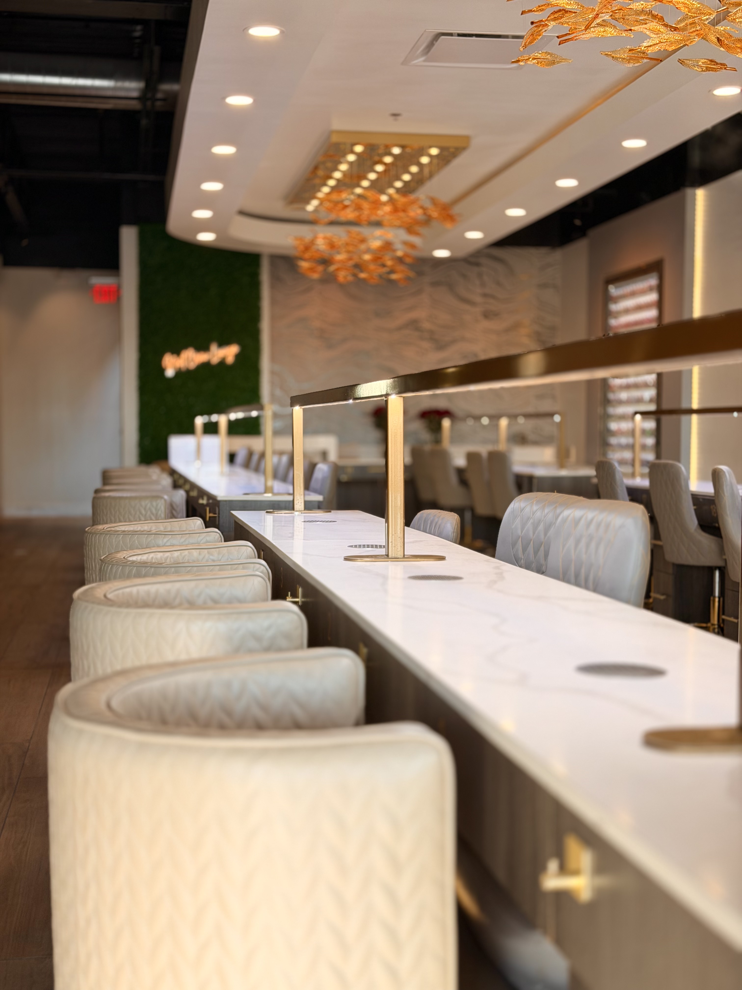 Nail Crew full salon with marble manicure stations and warm ambient lighting