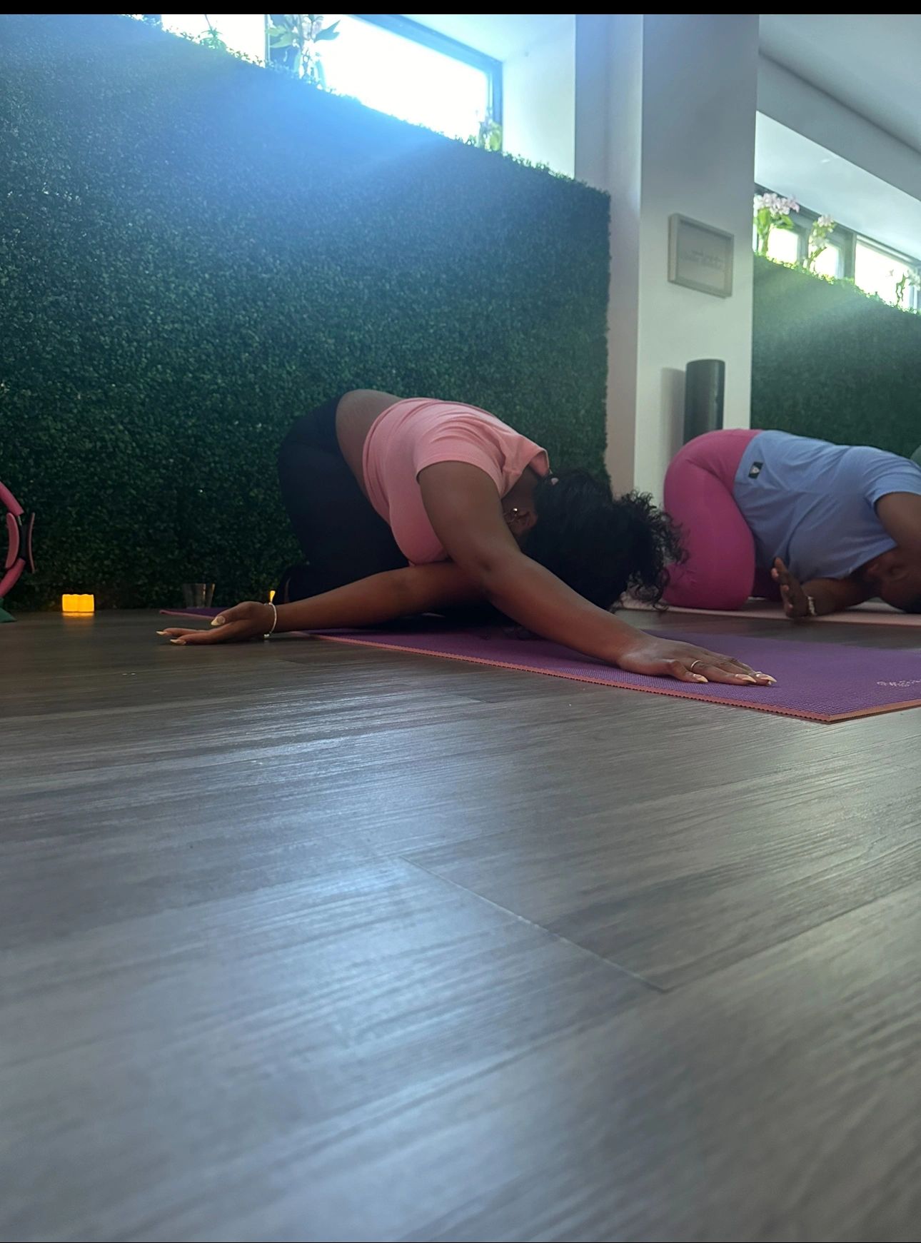 Instructor guiding a client on Pilates equipment