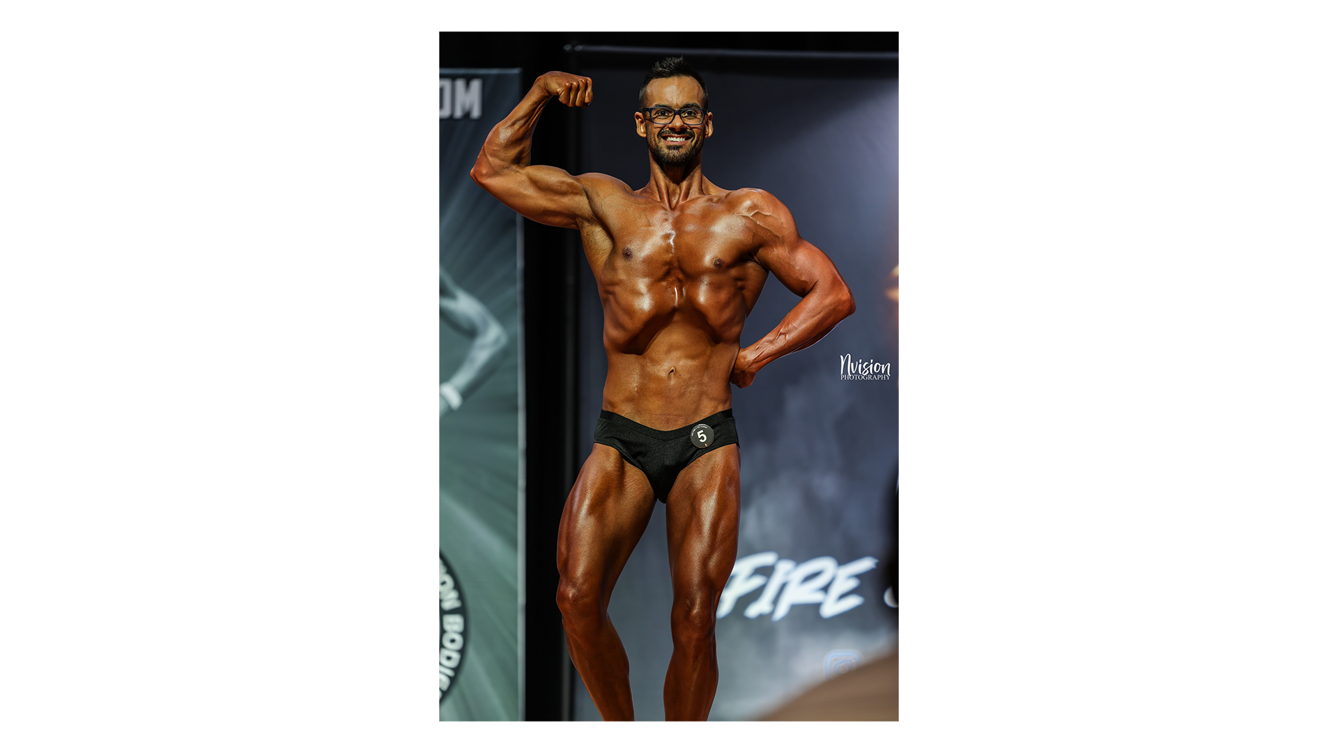Competitor performing classic vacuum pose under stage lights