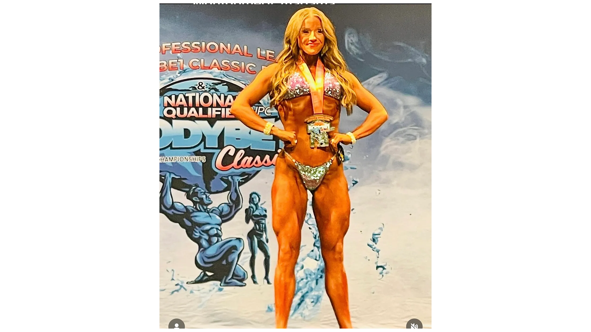 Fit Body Physiques bikini competitor with medal on stage