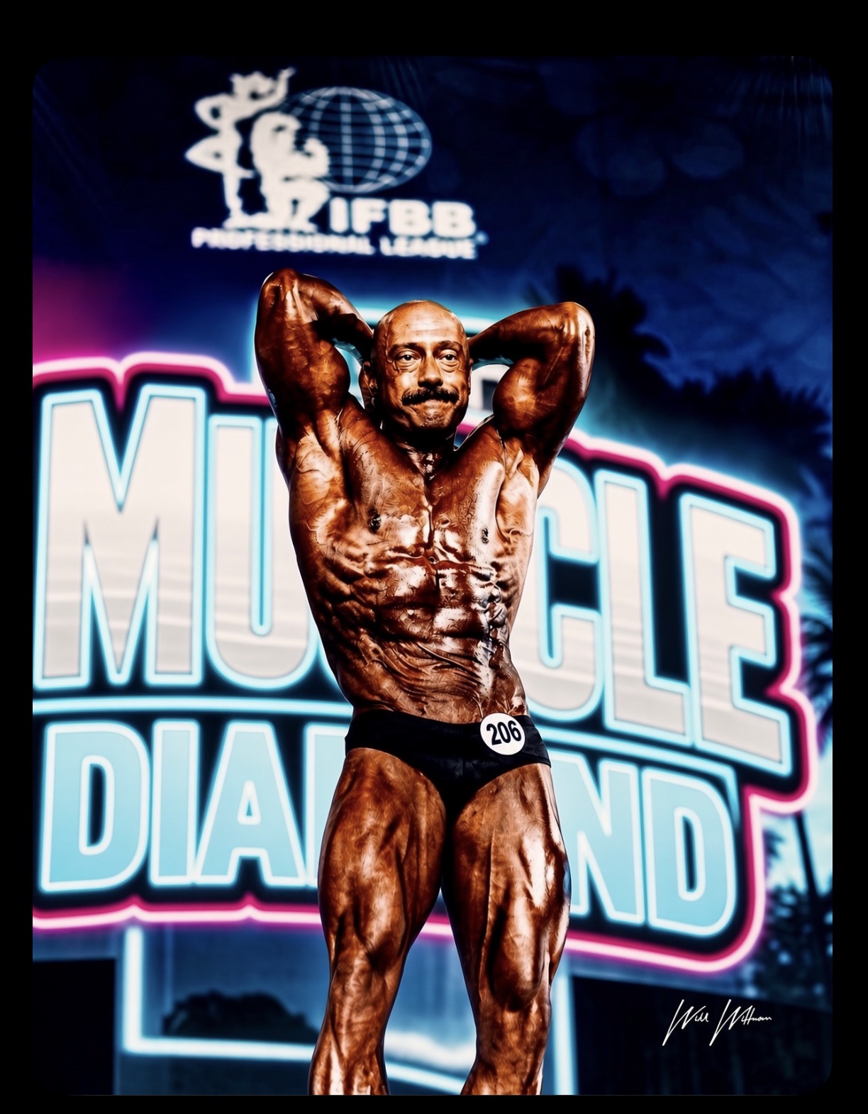 Physique competitor posing under the lights