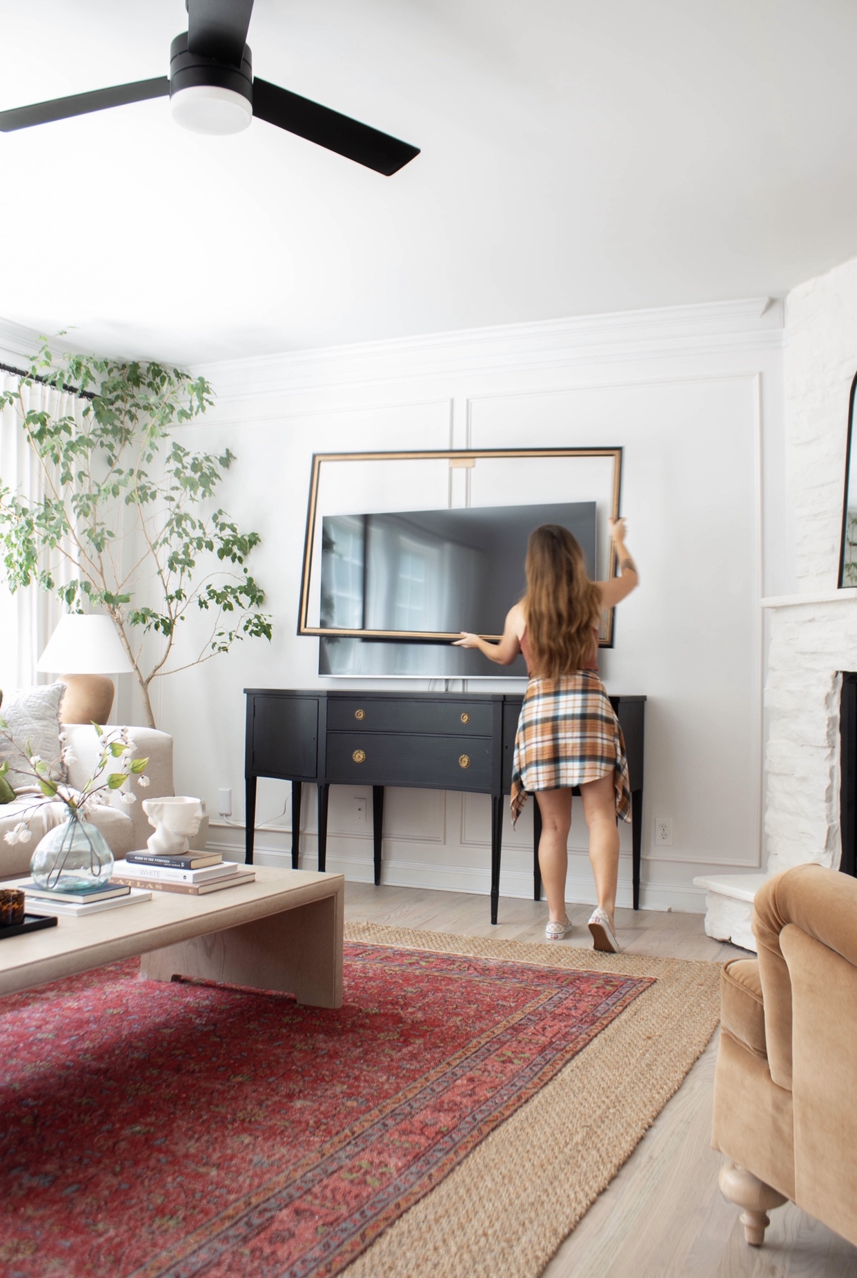 Real homeowner easily snapping magnetic Deco TV Frame onto mounted Samsung Frame TV
