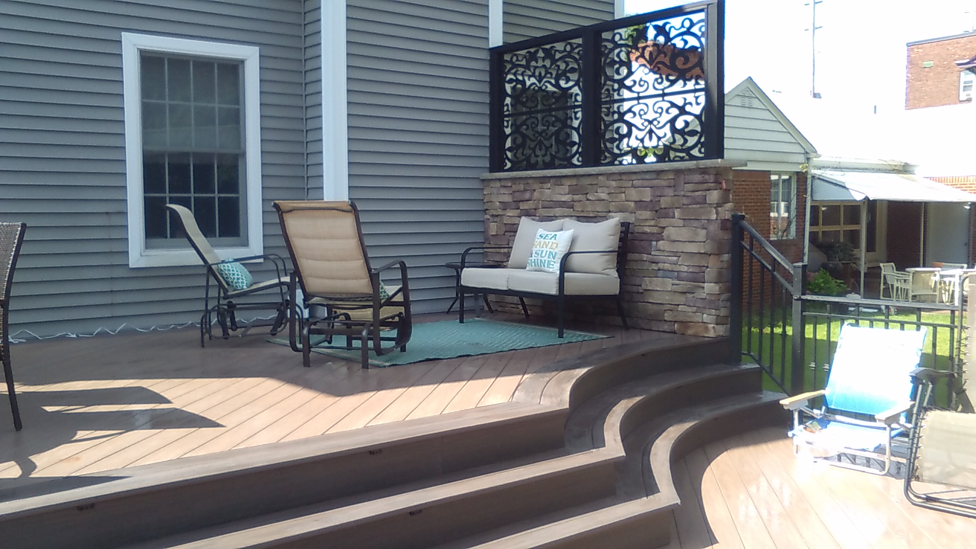 Multi-Tier Composite Deck with Cascading Radiused Steps & Stone Privacy Screen