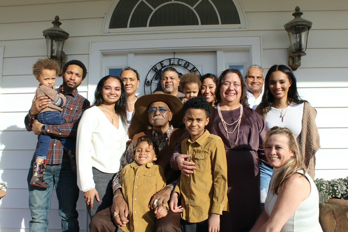 A diverse family standing in the doorway of their new home