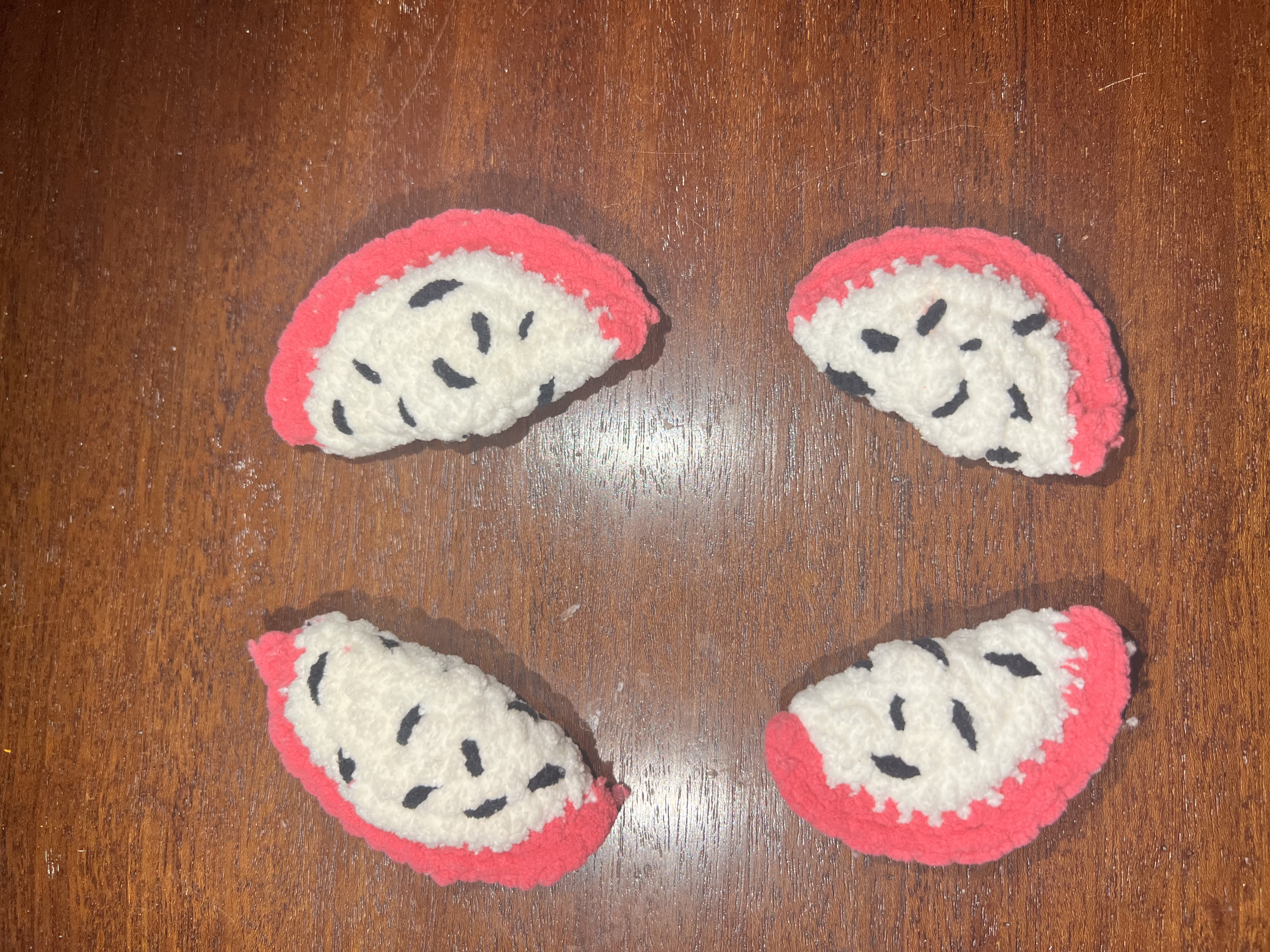 All four completed dragon fruit flippers laid out on the wooden table