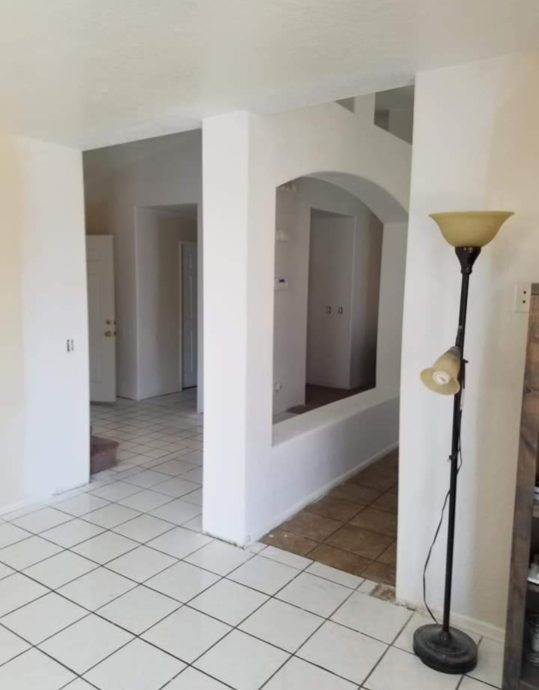 Smooth finished interior hallway with crisp arched drywall framing and spotless paint