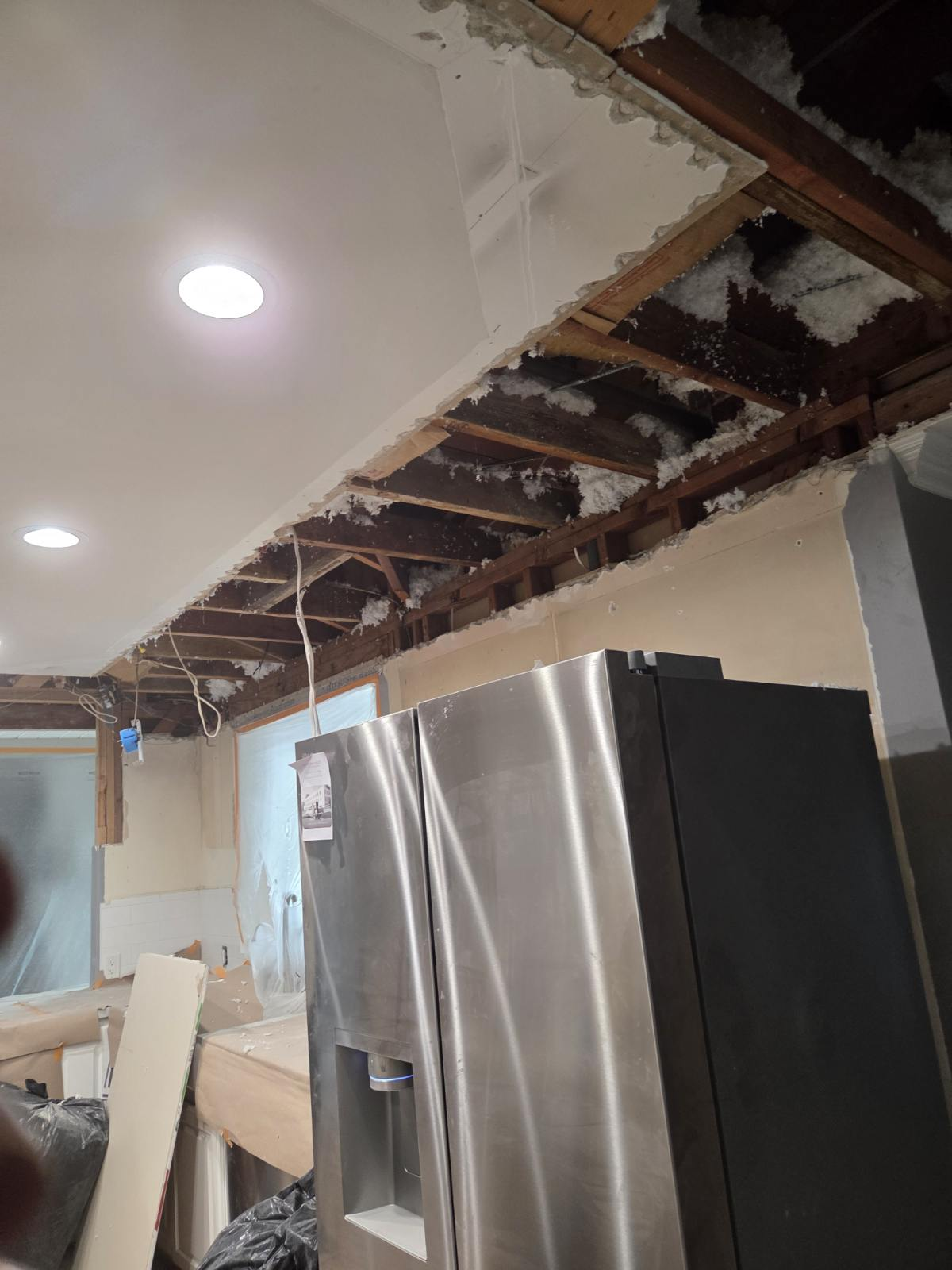 Kitchen ceiling drywall removal and soffit framing repair during remodel