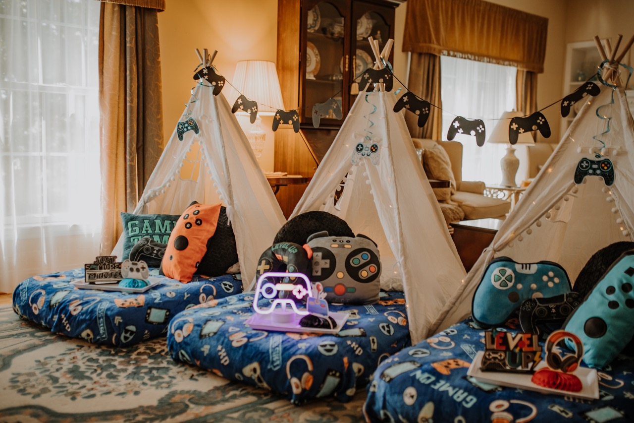 Full room setup of 3 Level Up gamer teepees with controller garland and themed pillows