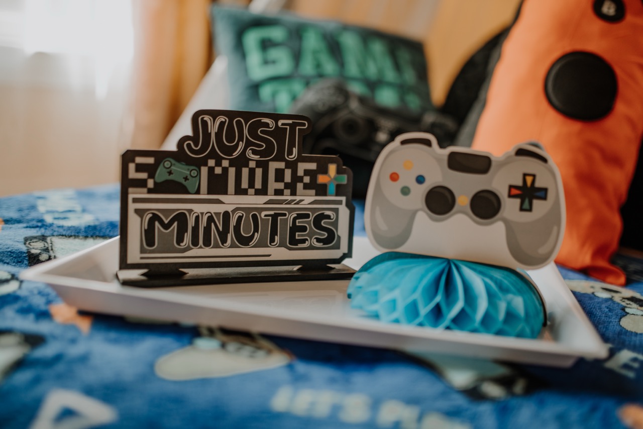 Level Up styling tray with Just 5 More Minutes sign and controller decor
