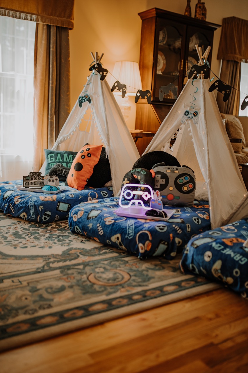 Level Up gamer sleepover setup with plush controller cushions and gamer bedding