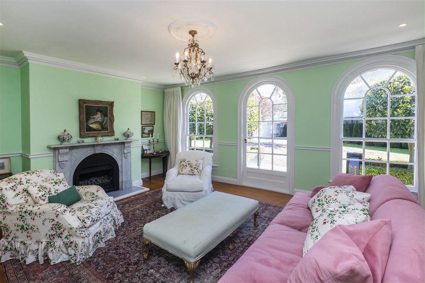 Finished heritage Christchurch living room with immaculate painted arched windows, fireplace, and cornices