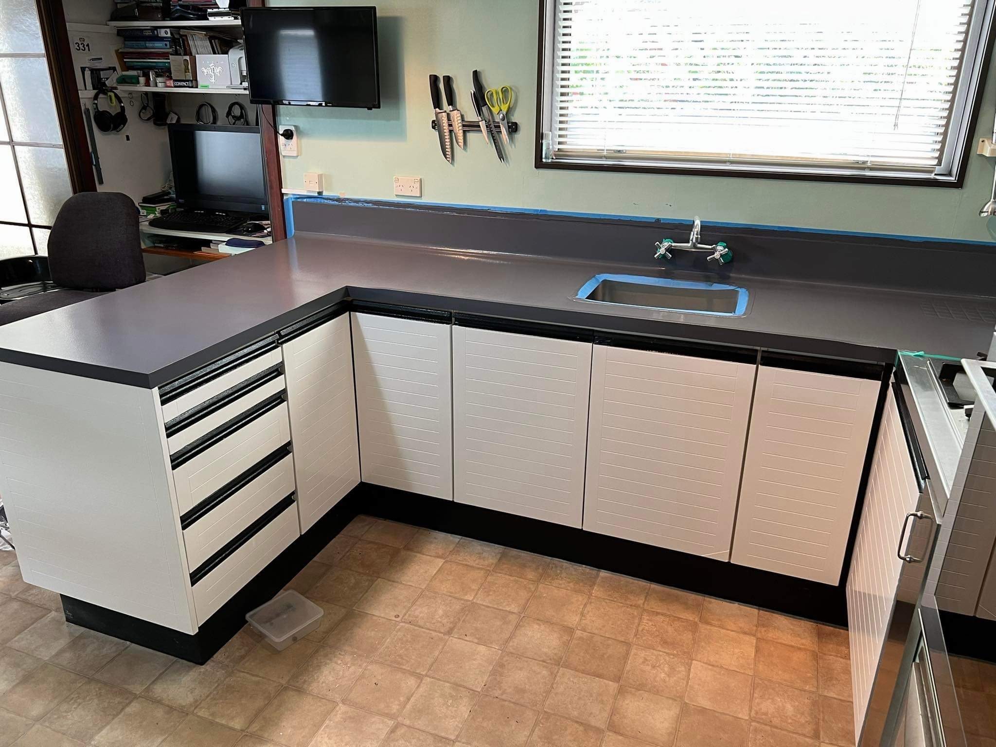 Refreshed white painted kitchen cabinetry with dark benchtop by Garden City Painters Christchurch