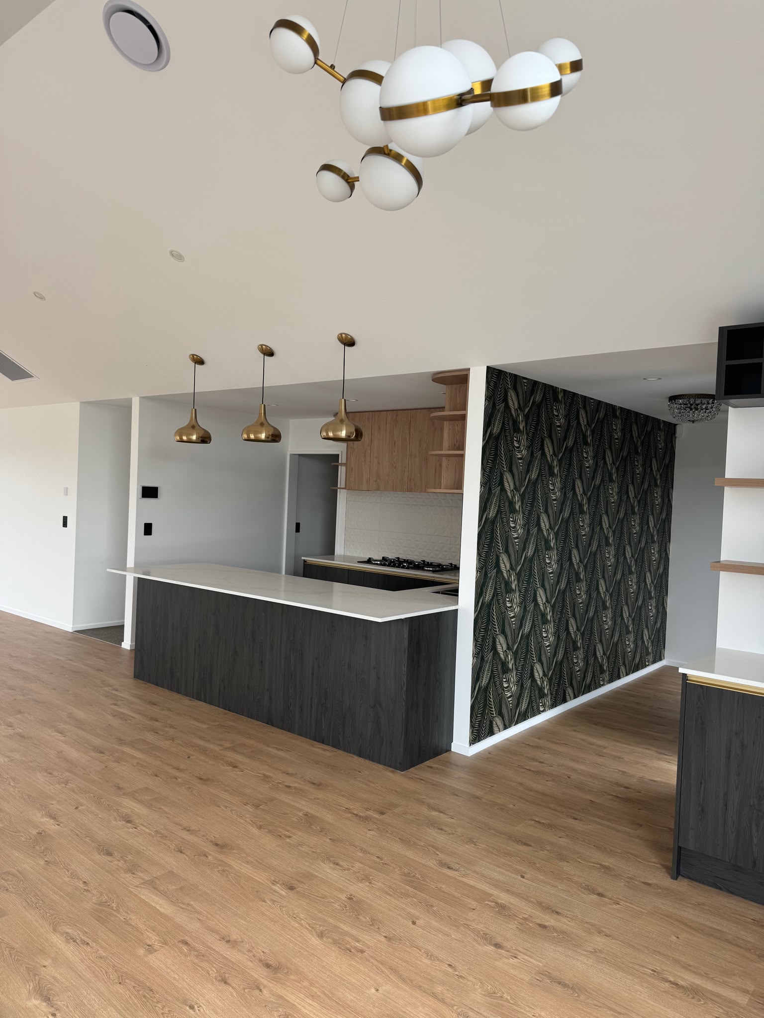 Finished open-plan kitchen and living area with pristine painted walls and ceiling completed by Garden City Painters