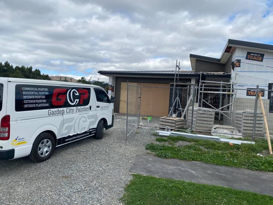 Garden City Painters van on site with scaffolding at a Christchurch build