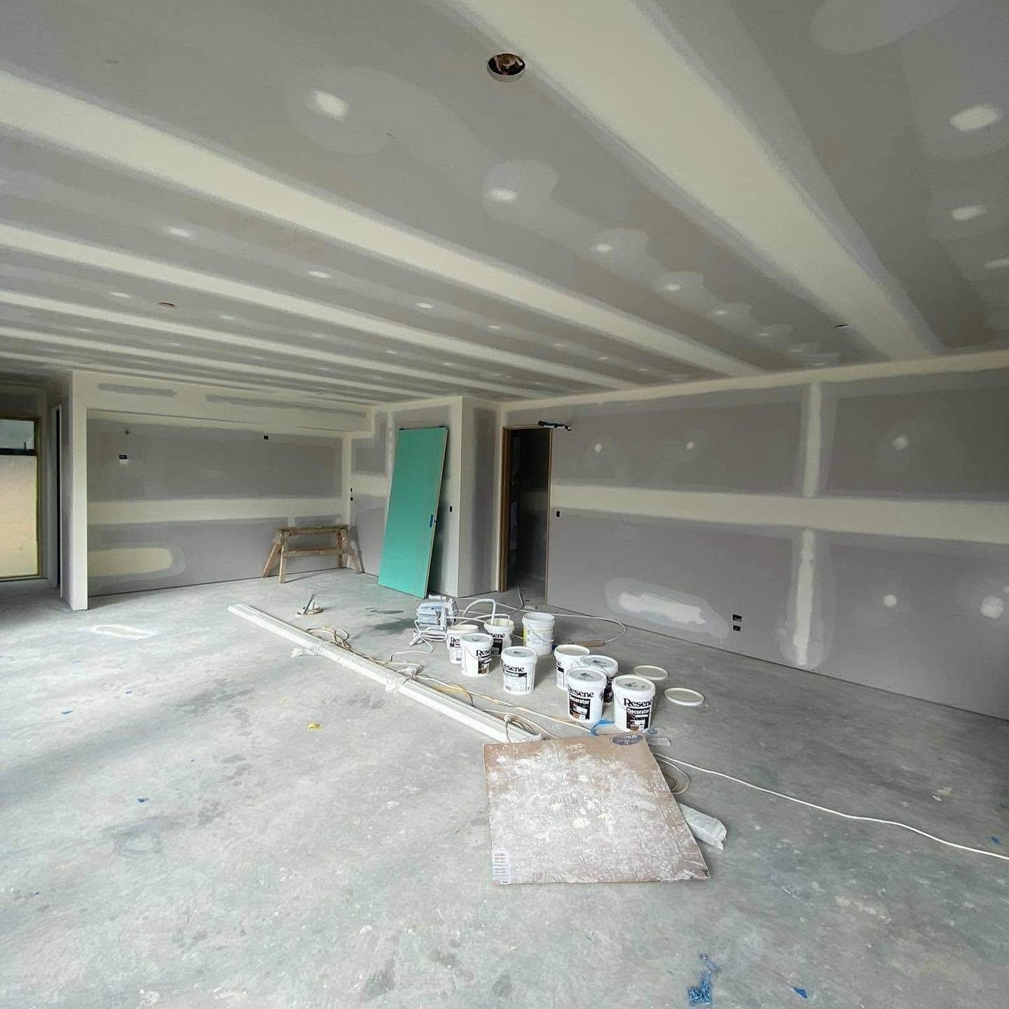 Interior preparation and gib-stopping work on site, with Resene paint ready for the finish coat