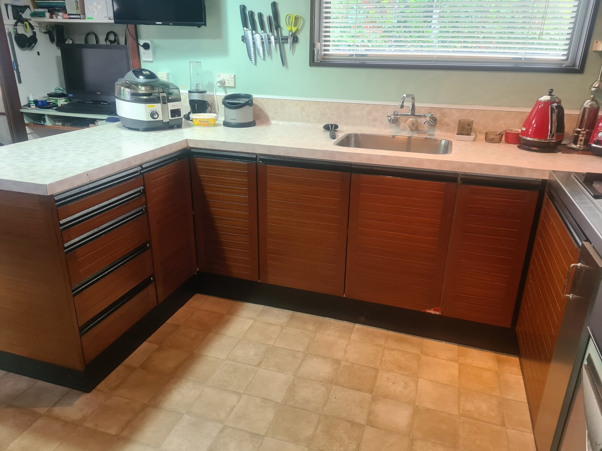 Original dated brown timber kitchen cabinetry before preparation and painting