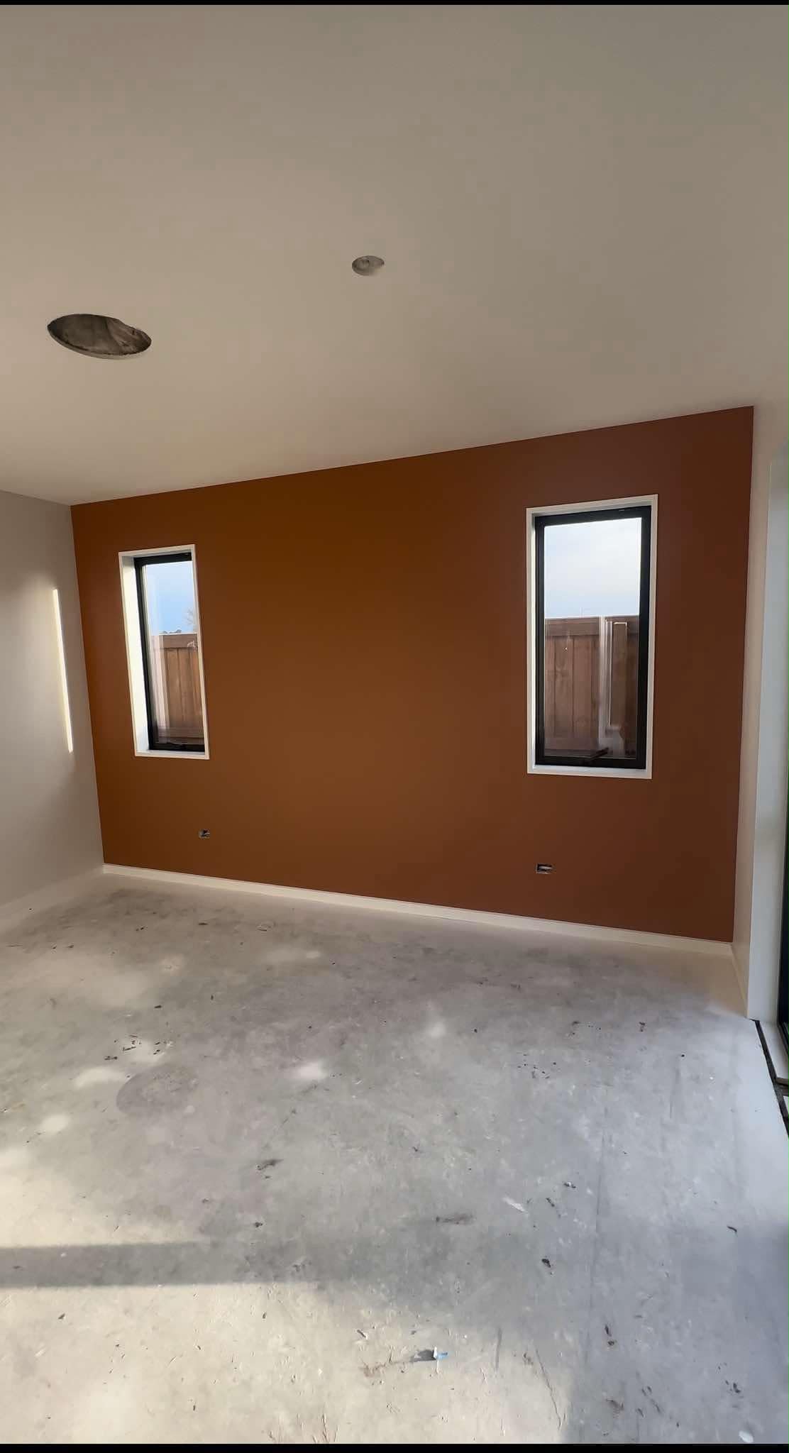 Christchurch interior room with warm terracotta feature wall and crisp painted trim