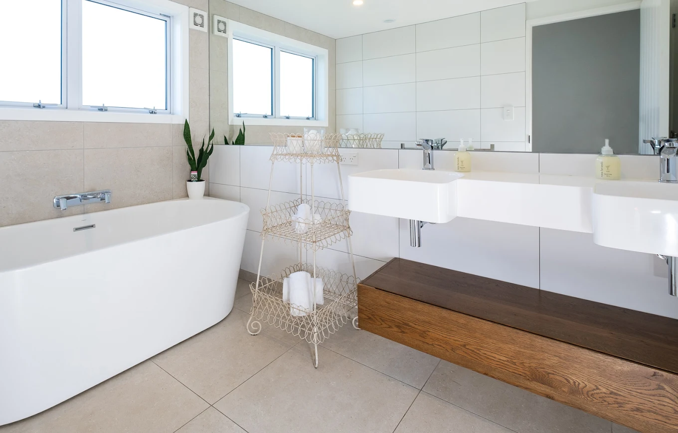 Private ensuite bathroom with double vanity and freestanding tub