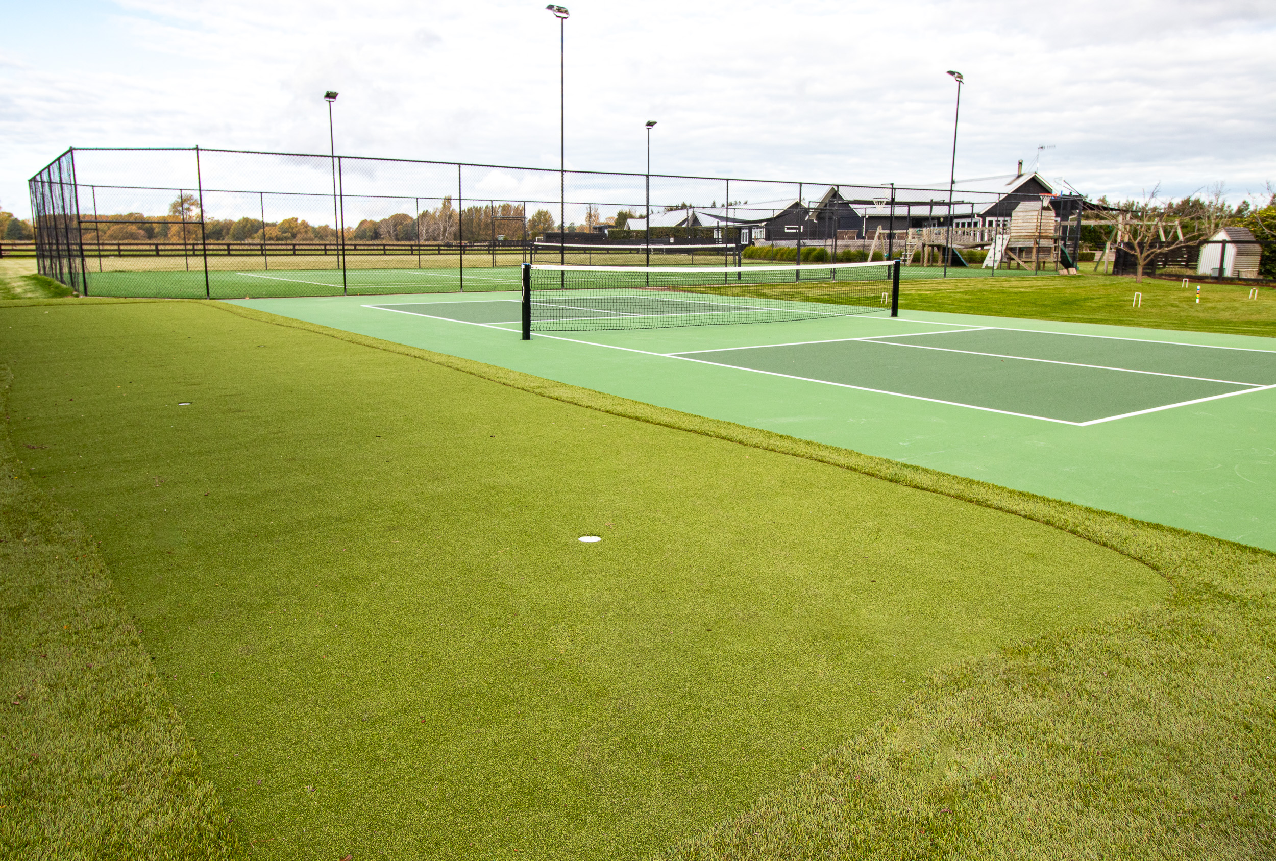 Full-size tennis and pickleball courts on retreat grounds