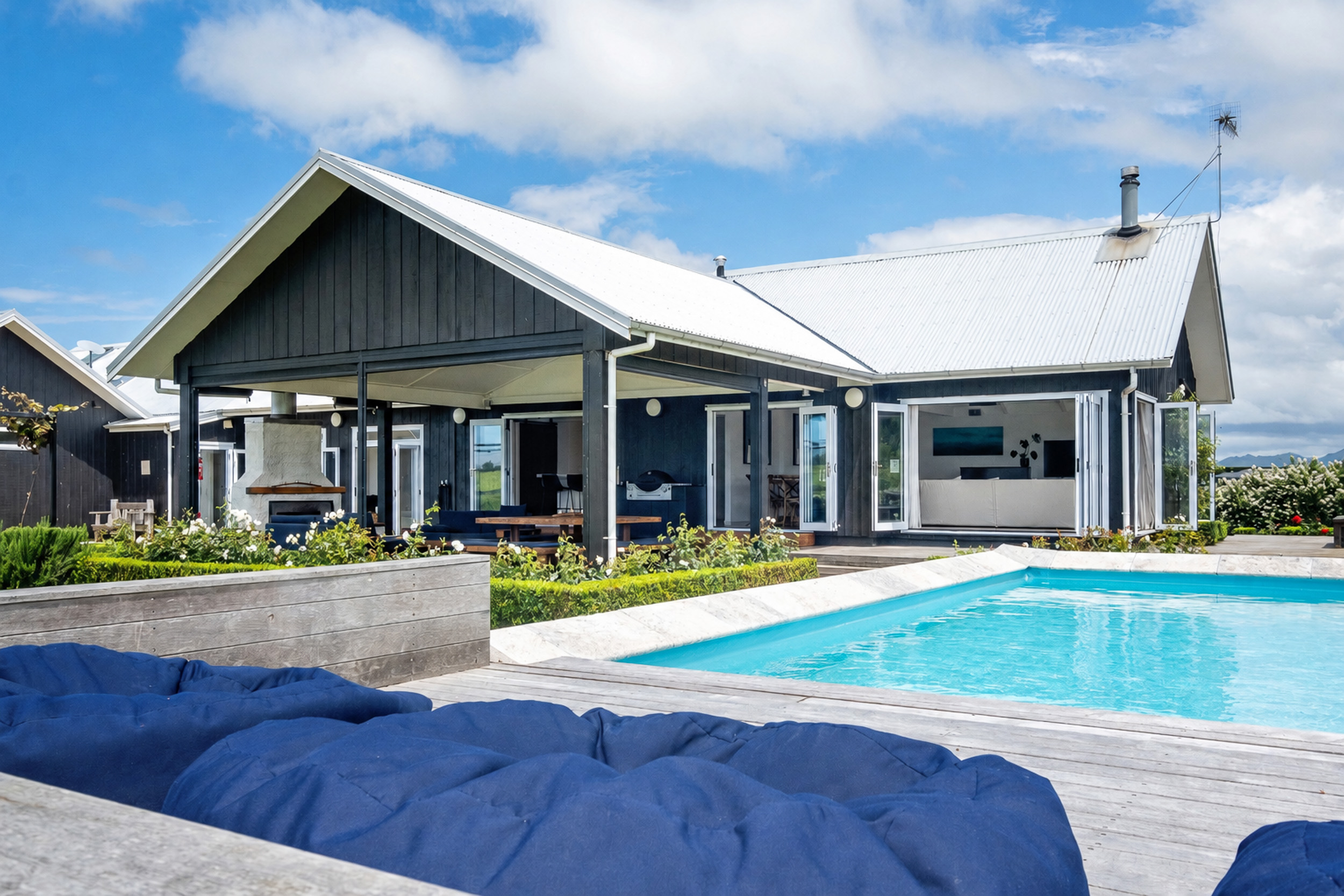 Lawn Road Retreats sparkling pool, sun deck, and lodge entertaining area
