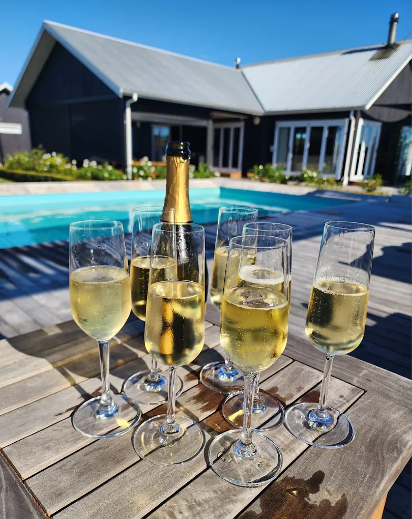 Poolside champagne celebration at Lawn Road Retreats Hawke's Bay
