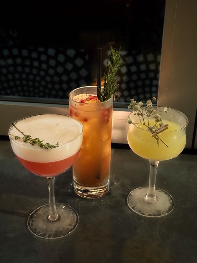 Trio of handcrafted craft cocktails at Et Voilà French Bistro bar