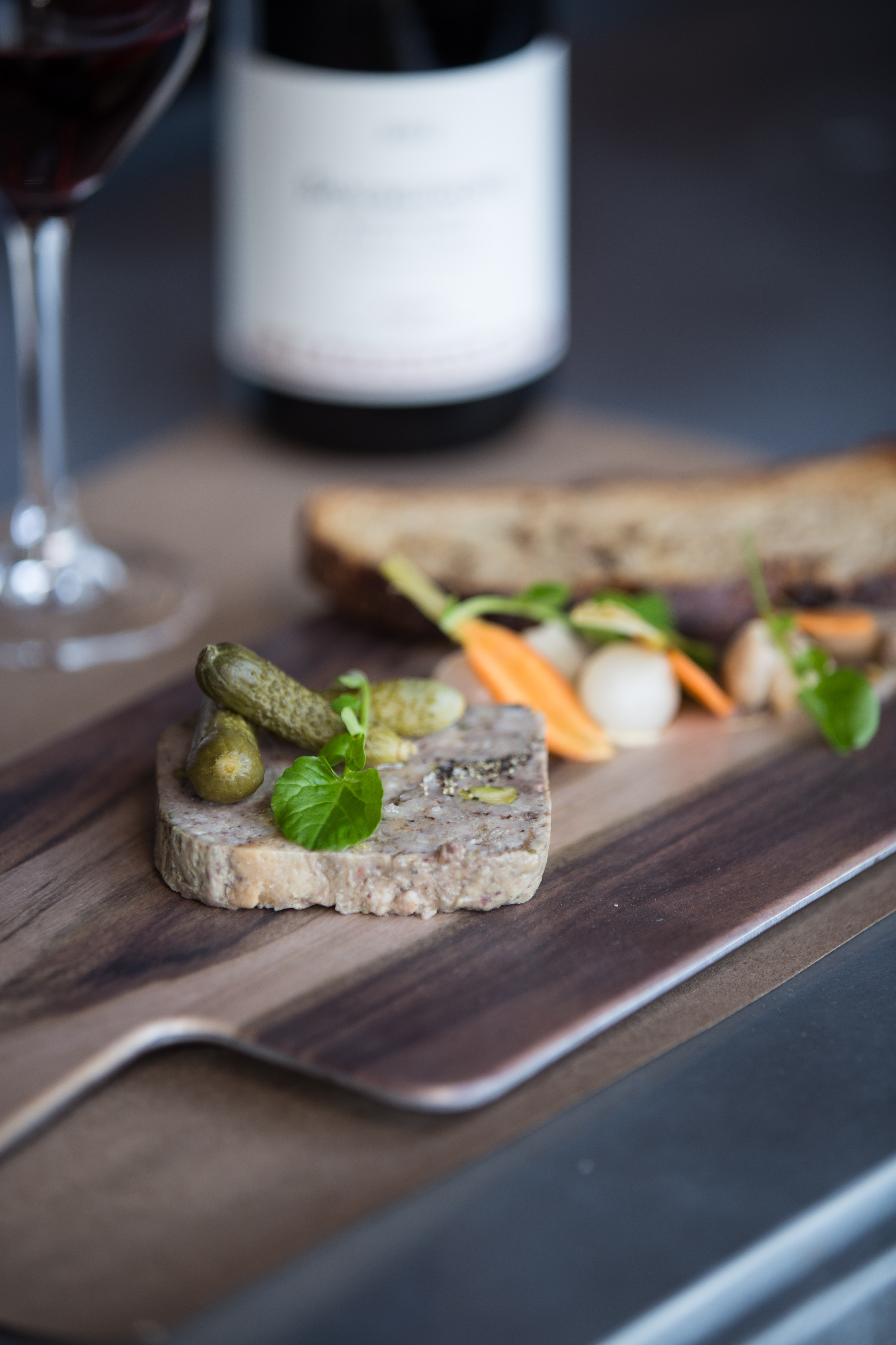 House-made pork terrine with cornichons and French red wine at Et Voilà French Bistro Happy Hour