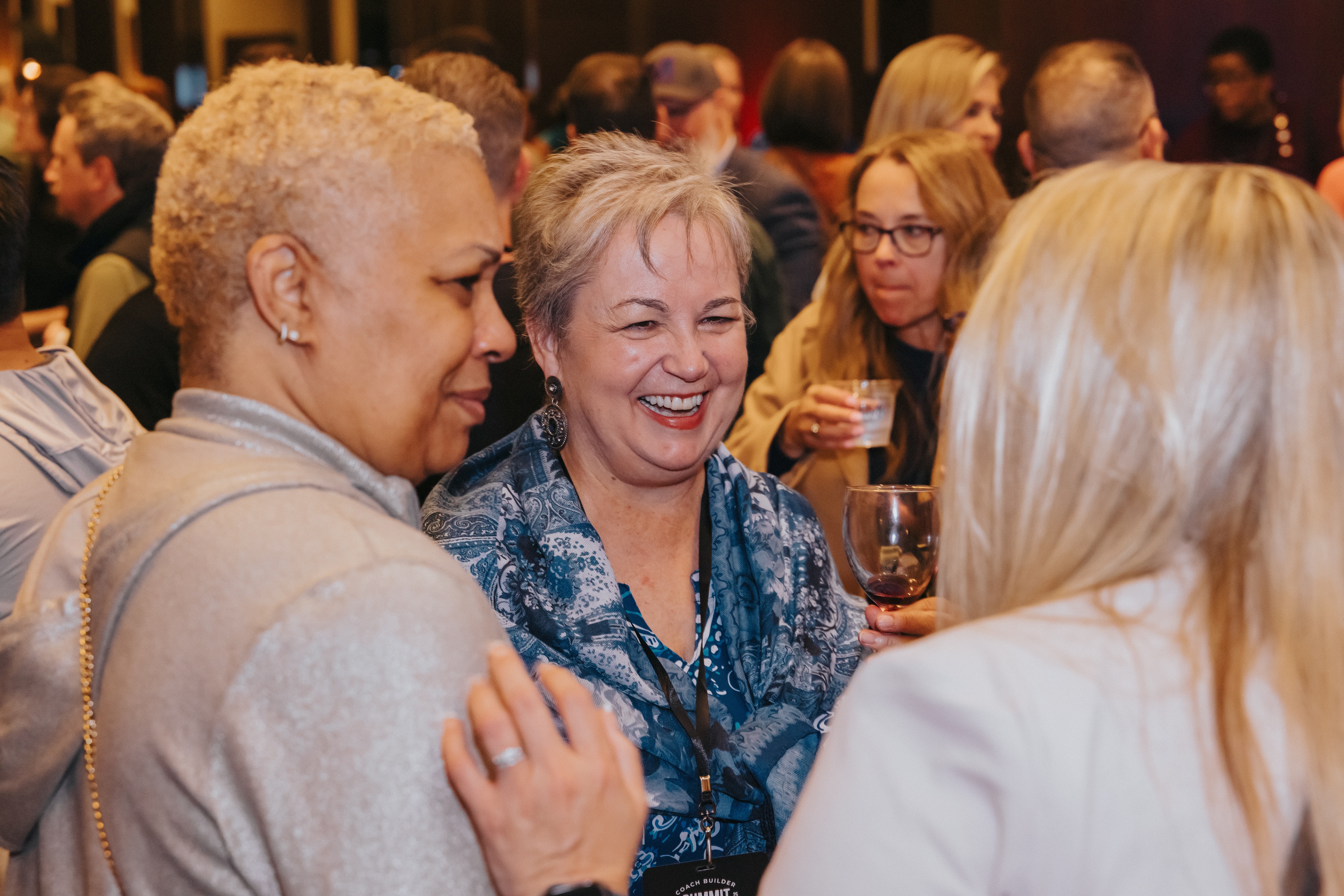 Sherri Bartin laughing and connecting in conversation with professionals