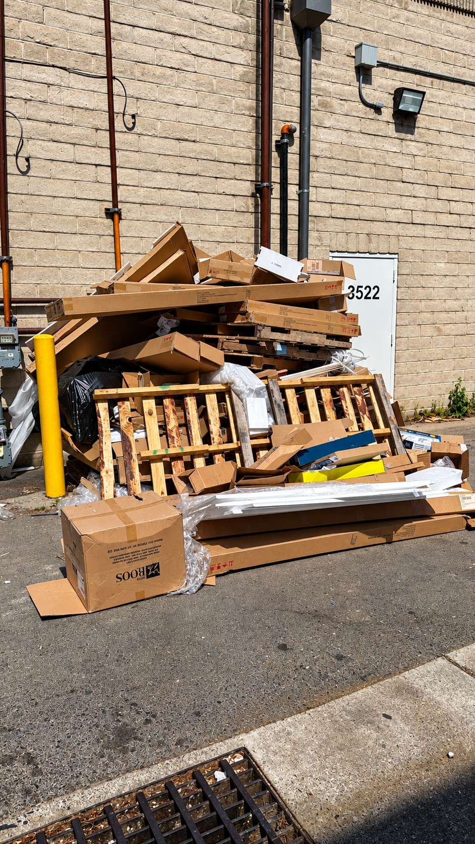 Commercial cardboard boxes and wooden pallets cleanup pile ready for haul off