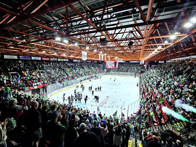 Raising Cane's River Center arena filled with cheering fans and players on the ice