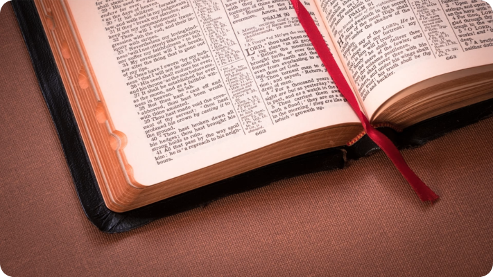 Open Holy Bible with red ribbon bookmark