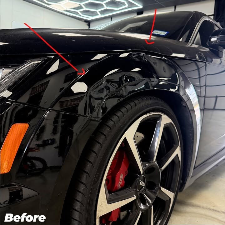 Damaged front fender dent with arrow marker before repair