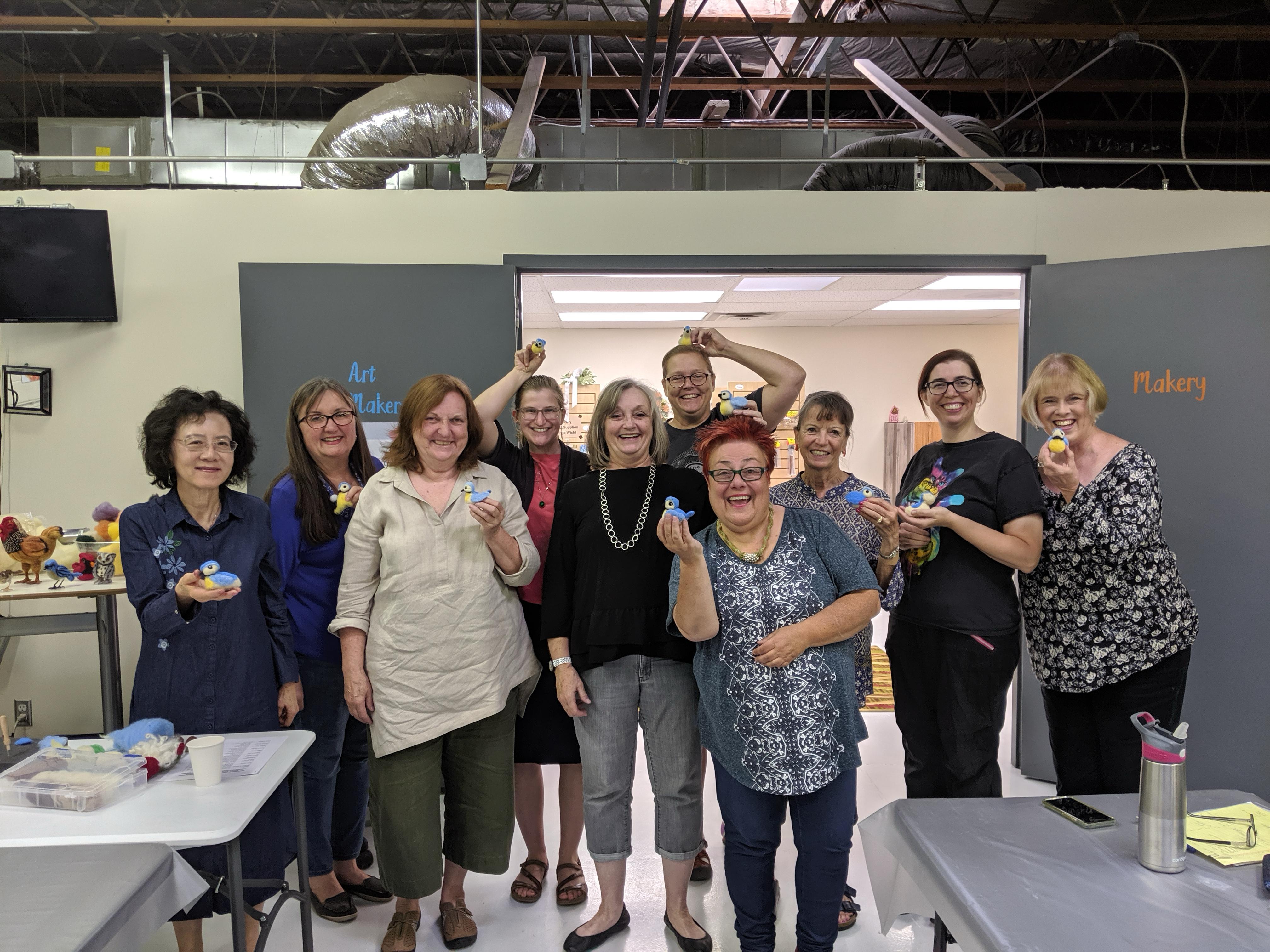 What a Felt Party Can Look Like: Smiling women gathered together with finished felt crafts